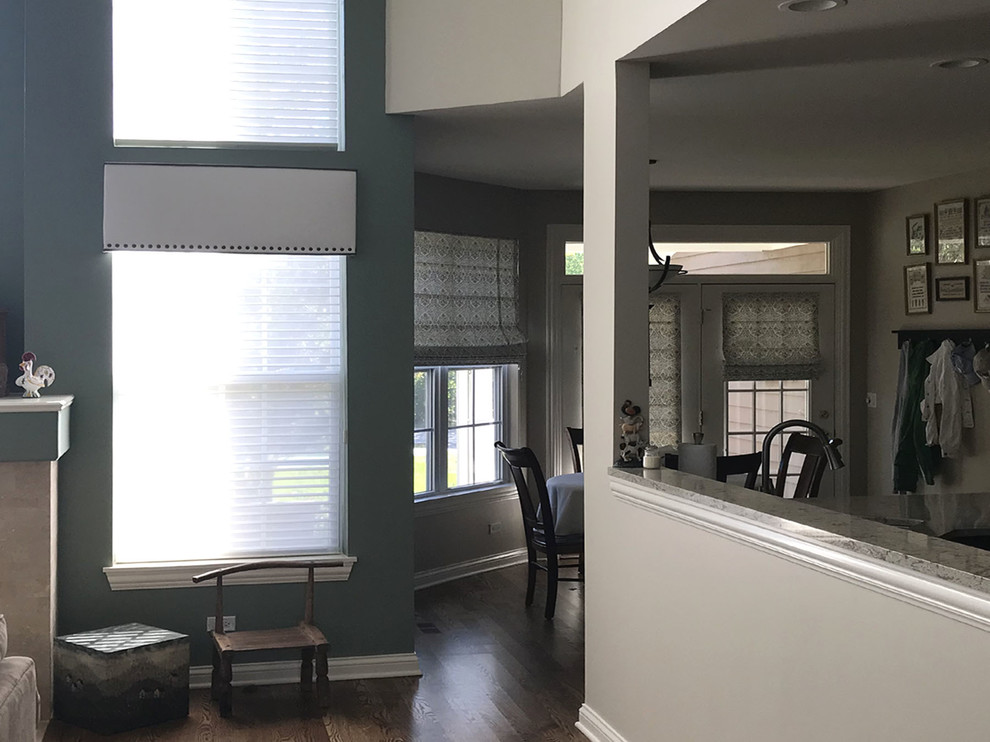 Example of a mid-sized classic formal and open concept medium tone wood floor and brown floor living room design in Chicago with gray walls, a standard fireplace, a tile fireplace and no tv