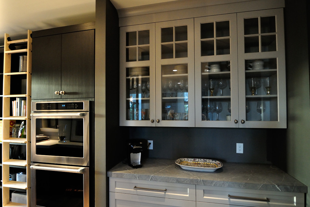 Photo of a large contemporary galley kitchen pantry in Burlington with recessed-panel cabinets, grey cabinets, soapstone benchtops and stainless steel appliances.