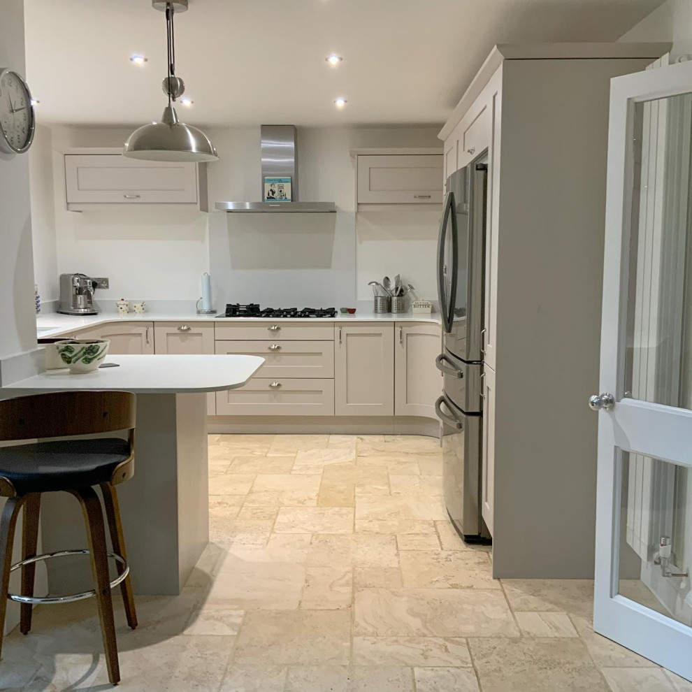 Inspiration for a large modern eat-in kitchen in Buckinghamshire with shaker cabinets, quartzite benchtops, white splashback, engineered quartz splashback, stainless steel appliances, a peninsula and white benchtop.