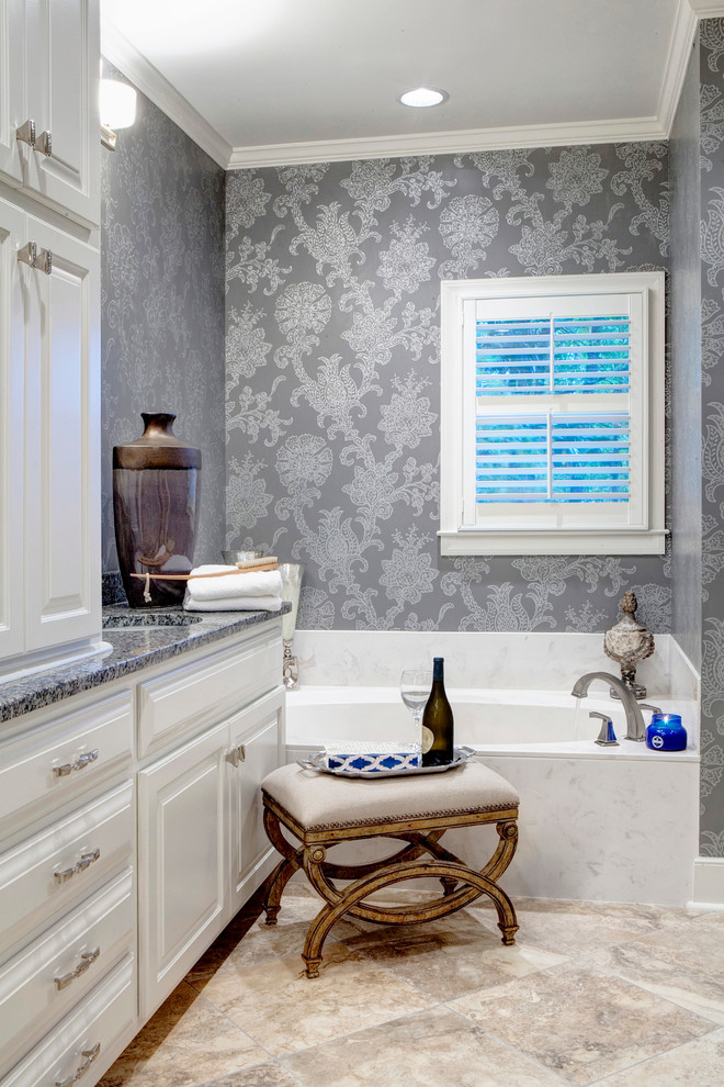 This is an example of a large transitional master bathroom in Charleston with an undermount sink, raised-panel cabinets, white cabinets, granite benchtops, an alcove tub, an alcove shower, gray tile, porcelain tile, grey walls and travertine floors.