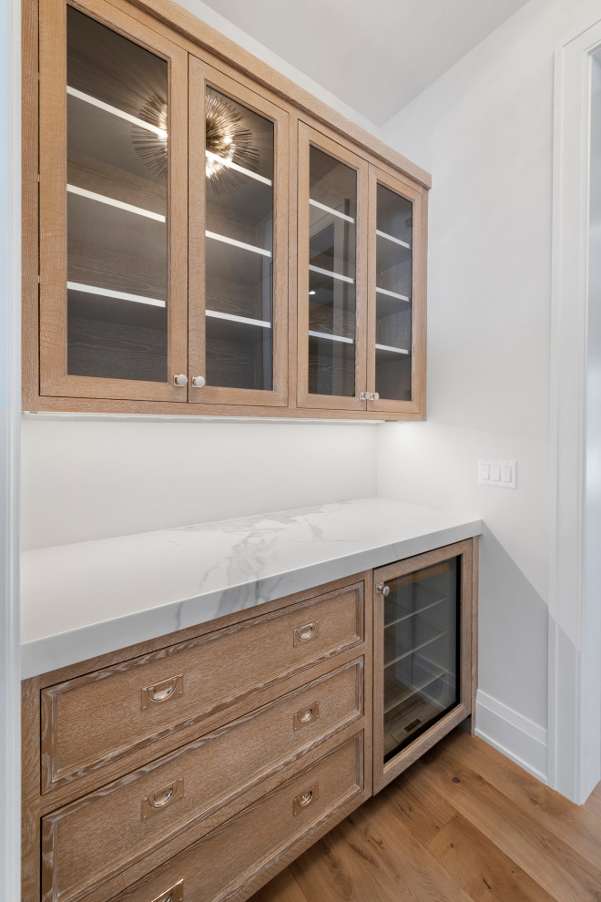 Large transitional kitchen photo in Chicago with recessed-panel cabinets, light wood cabinets and marble countertops