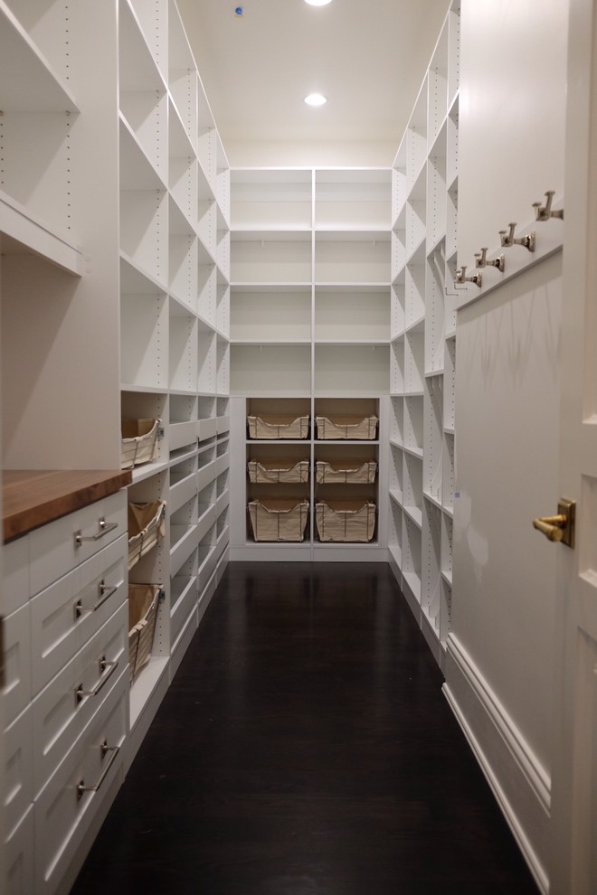 Large traditional u-shaped kitchen pantry in Chicago with white cabinets, wood benchtops, white splashback, dark hardwood floors, no island and open cabinets.