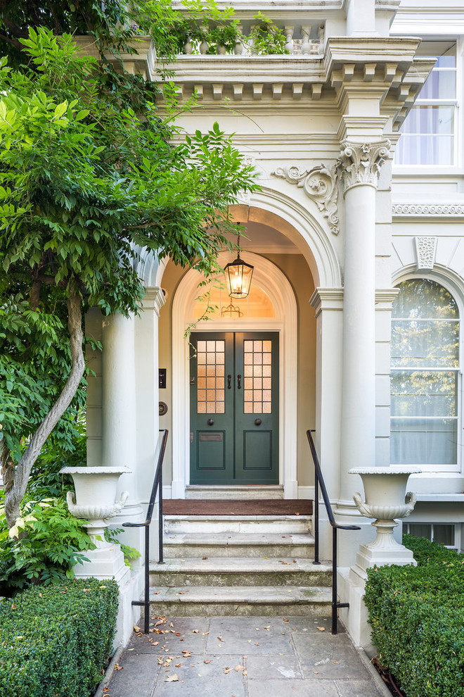 This is an example of a traditional entryway in Other with a double front door and a green front door.