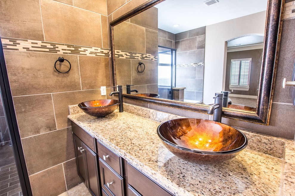 Example of a mid-sized transitional master beige tile ceramic tile home design design in Austin with flat-panel cabinets, brown cabinets, a one-piece toilet, beige walls, a vessel sink and granite countertops