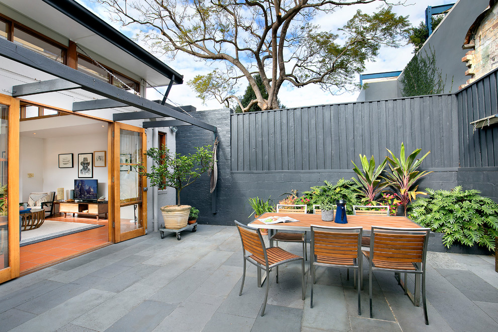 Inspiration for a mid-sized contemporary backyard patio in Sydney with no cover.