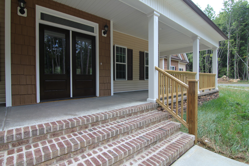 Photo of an expansive country front yard verandah in Raleigh with concrete slab and a roof extension.