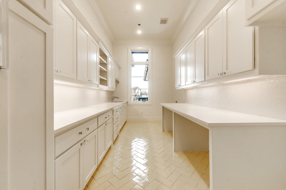 Large contemporary galley dedicated laundry room in Dallas with an undermount sink, shaker cabinets, white cabinets, quartz benchtops, white walls, ceramic floors and a side-by-side washer and dryer.