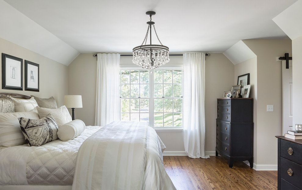 Mid-sized traditional master bedroom in Minneapolis with medium hardwood floors, no fireplace and beige walls.