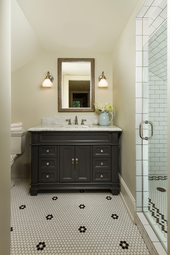 Mid-sized country master bathroom in Minneapolis with beaded inset cabinets, blue cabinets, an alcove shower, a two-piece toilet, white tile, subway tile, beige walls, mosaic tile floors and marble benchtops.
