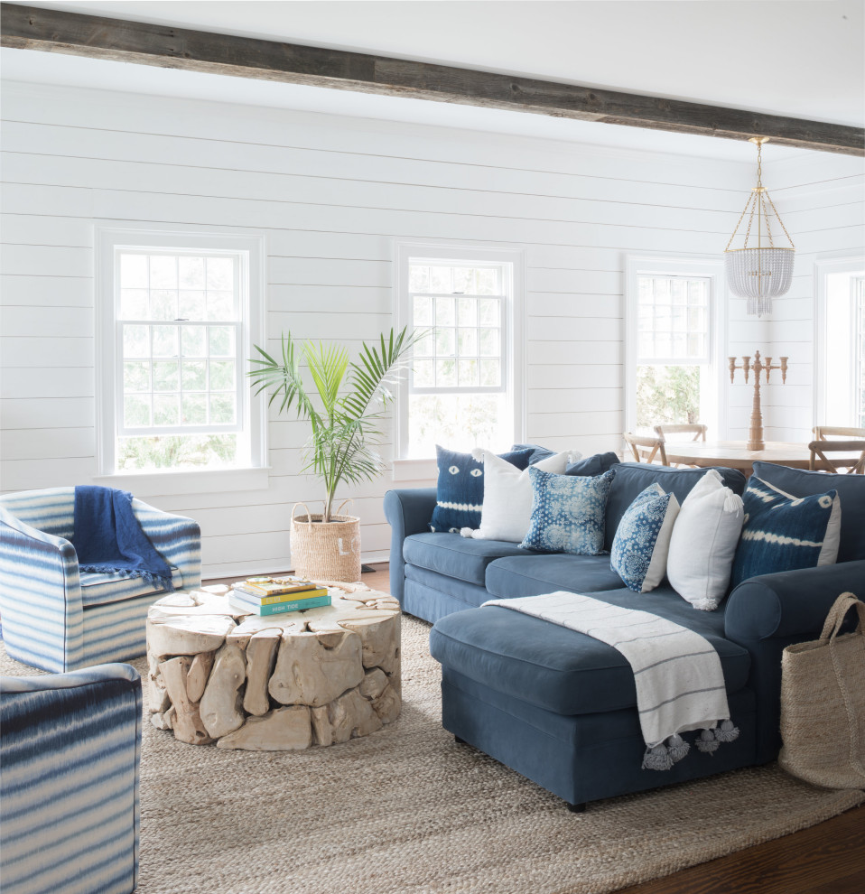 Design ideas for a large beach style open concept living room in New York with white walls, dark hardwood floors, brown floor, exposed beam and planked wall panelling.