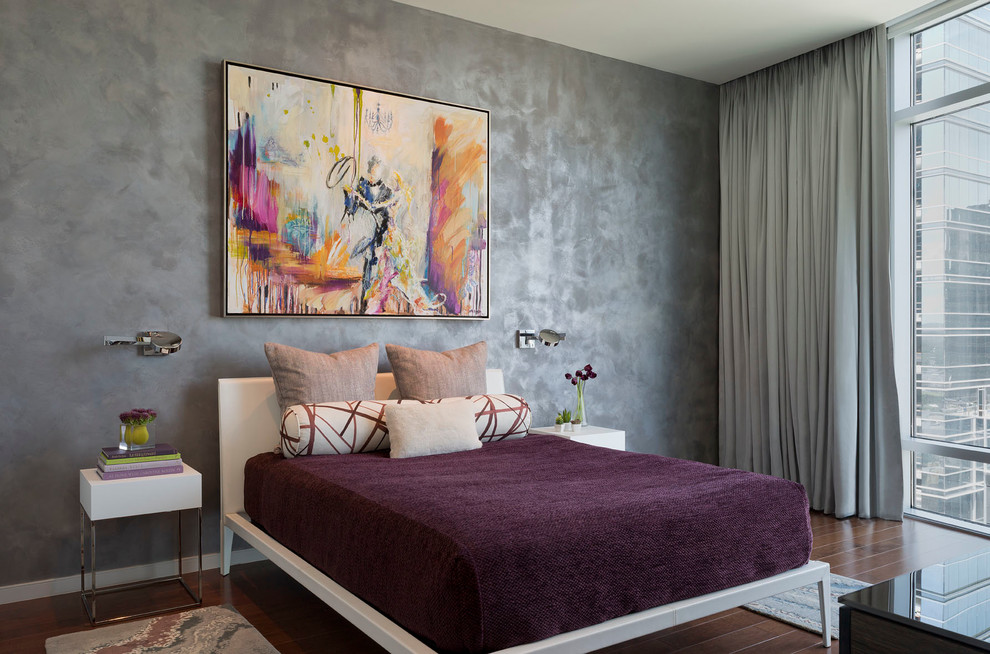 Contemporary master bedroom in Austin with grey walls and dark hardwood floors.