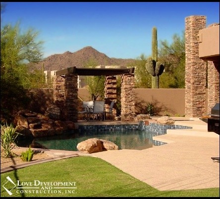 Inspiration for a small transitional backyard custom-shaped pool house remodel in Phoenix with decking