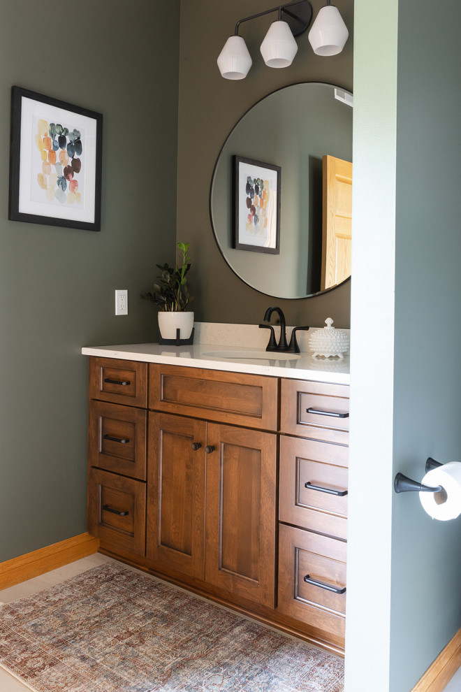 Example of a transitional vinyl floor, white floor and single-sink bathroom design with shaker cabinets, medium tone wood cabinets, green walls, quartz countertops, white countertops and a built-in vanity