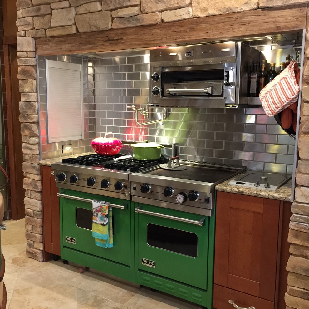 Photo of a modern eat-in kitchen in Sacramento with metallic splashback, metal splashback, medium wood cabinets, coloured appliances, travertine floors, beige floor and shaker cabinets.
