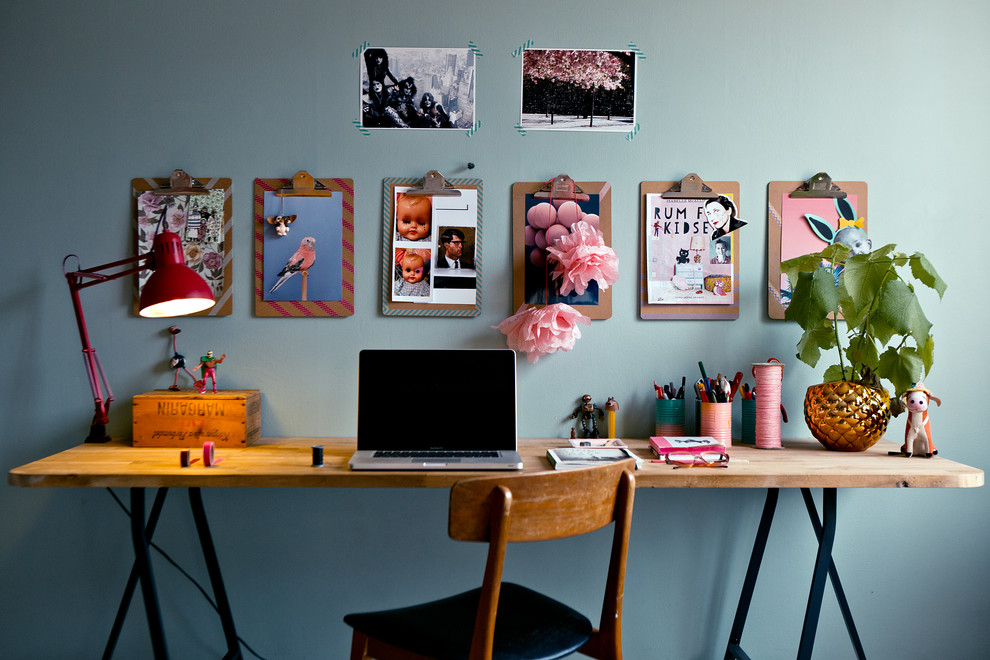 Photo of a small eclectic study room in Stockholm with blue walls, a freestanding desk and no fireplace.