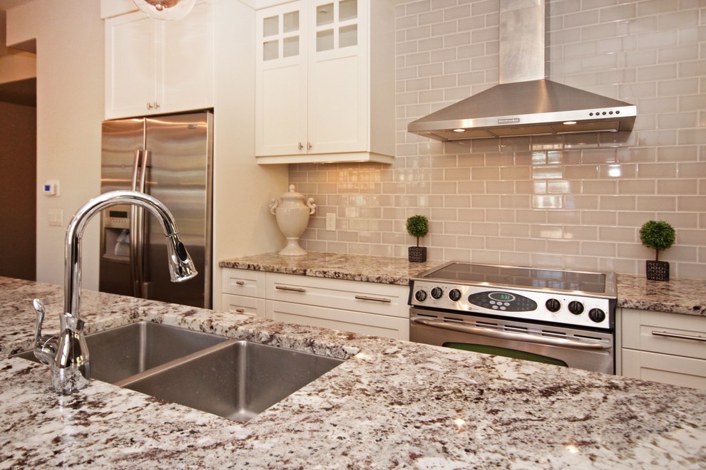 Example of a mid-sized transitional single-wall medium tone wood floor eat-in kitchen design in Calgary with a double-bowl sink, white cabinets, granite countertops, stainless steel appliances and an island