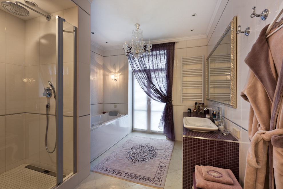 Photo of a mid-sized traditional master bathroom in Saint Petersburg with raised-panel cabinets, white cabinets, a hot tub, an alcove shower, a wall-mount toilet, beige tile, porcelain tile, beige walls, porcelain floors, a drop-in sink, beige floor and a hinged shower door.