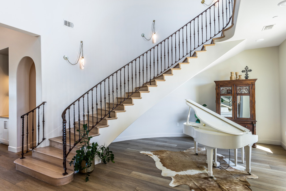Curved Staircase and Great Room | Tuscan Farmhouse