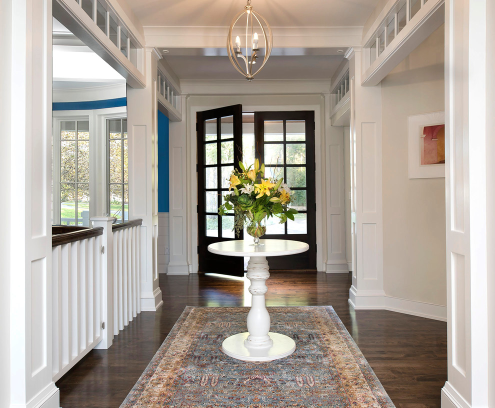 Inspiration for a mid-sized transitional dark wood floor and brown floor foyer remodel in Milwaukee with a dark wood front door and beige walls