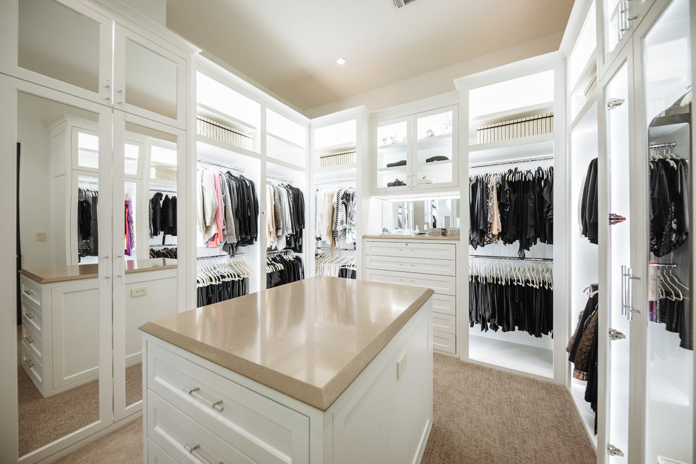 Design ideas for a large traditional gender-neutral dressing room in Dallas with white cabinets, carpet, recessed-panel cabinets and brown floor.