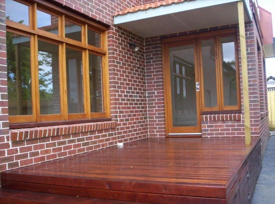 This is an example of a mid-sized traditional two-storey brick house exterior in Melbourne with a gable roof and a tile roof.