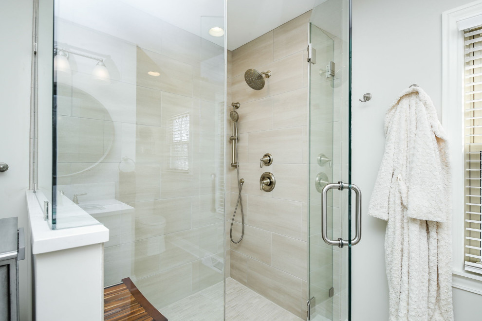 Photo of a transitional master bathroom in Chicago with white cabinets, a corner shower, white tile, ceramic tile, grey walls, ceramic floors, an undermount sink, engineered quartz benchtops, beige floor, a hinged shower door, white benchtops and a double vanity.