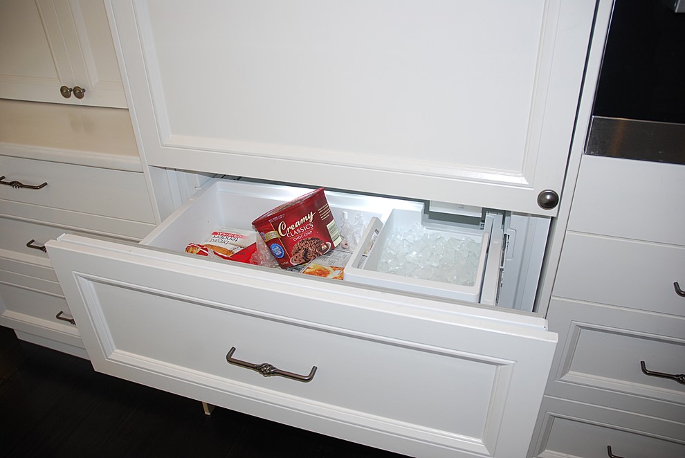 Large traditional u-shaped eat-in kitchen in Sydney with a farmhouse sink, shaker cabinets, white cabinets, solid surface benchtops, white splashback, subway tile splashback, stainless steel appliances, dark hardwood floors and no island.