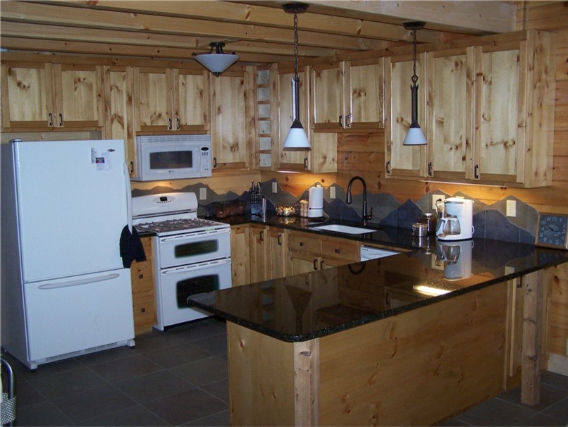 Example of a mid-sized mountain style u-shaped porcelain tile open concept kitchen design in Chicago with an undermount sink, shaker cabinets, light wood cabinets, granite countertops, blue backsplash, porcelain backsplash, white appliances and a peninsula