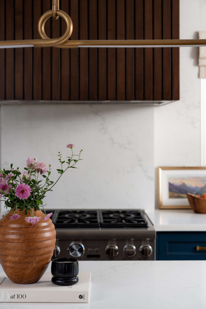 Eat-in kitchen - mid-sized transitional l-shaped medium tone wood floor and beige floor eat-in kitchen idea in Toronto with a farmhouse sink, shaker cabinets, blue cabinets, quartz countertops, white backsplash, quartz backsplash, stainless steel appliances, an island and white countertops