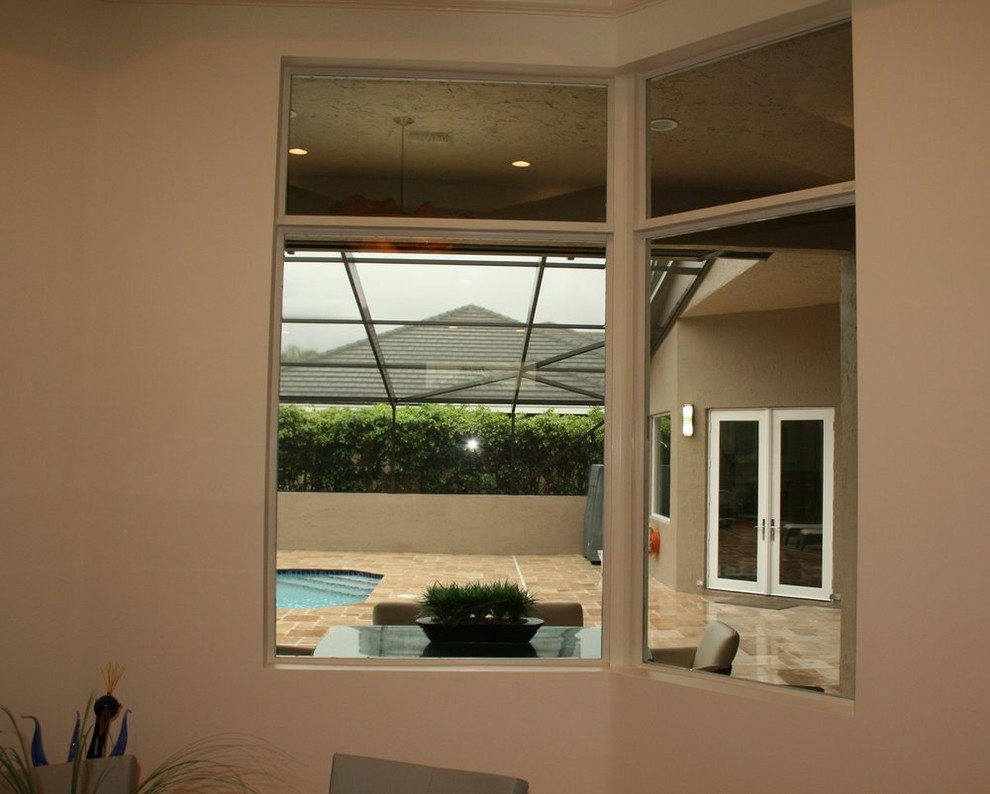Inspiration for an u-shaped enclosed kitchen remodel with an undermount sink, flat-panel cabinets, red cabinets, limestone countertops and an island