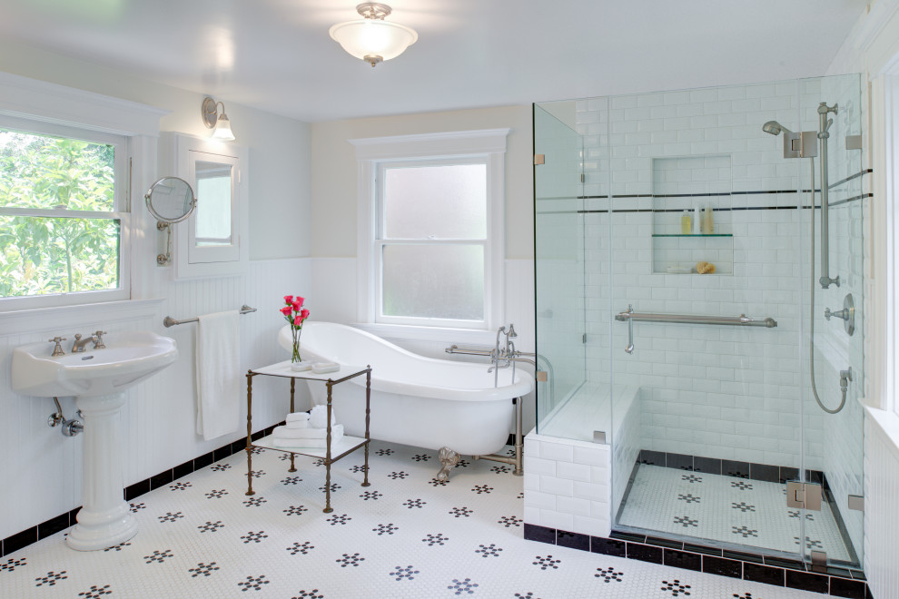 Photo of a large traditional master bathroom in San Francisco with a claw-foot tub, a corner shower, a two-piece toilet, white tile, ceramic tile, white walls, mosaic tile floors, a pedestal sink, white floor, a hinged shower door, a shower seat, a single vanity and panelled walls.