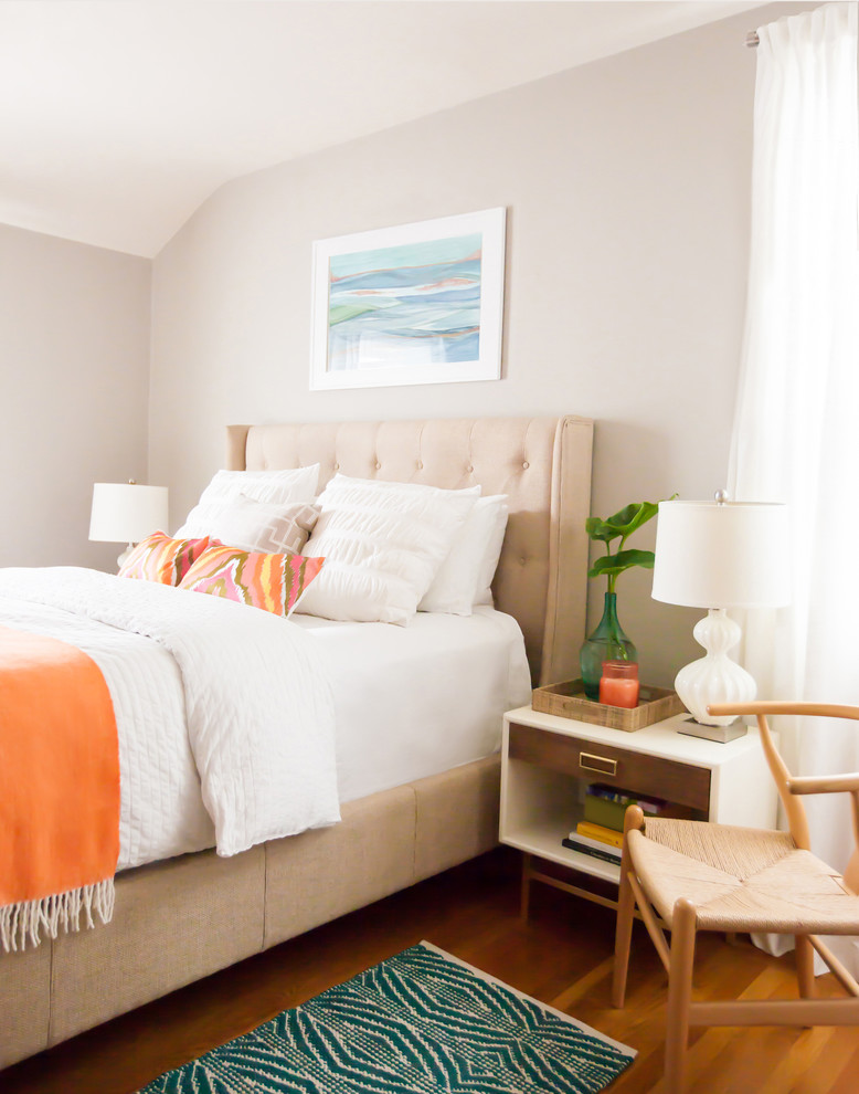 Photo of a beach style master bedroom in San Francisco with beige walls and medium hardwood floors.