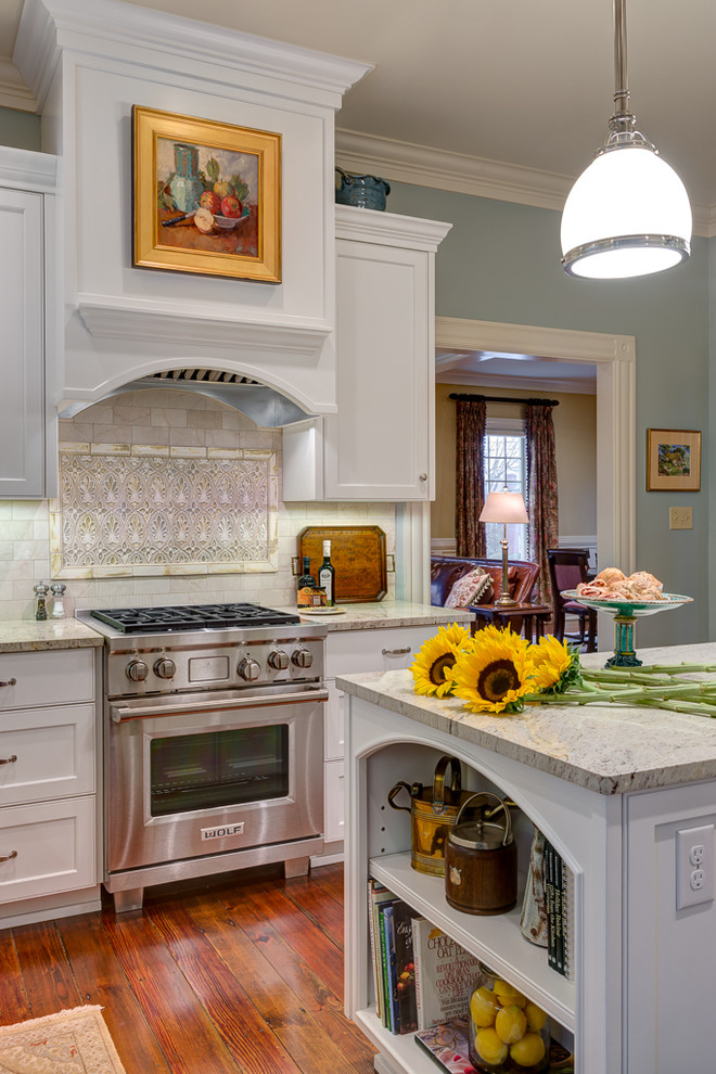 Inspiration for a traditional kitchen in Charlotte with shaker cabinets, white cabinets, white splashback, stainless steel appliances, dark hardwood floors and with island.