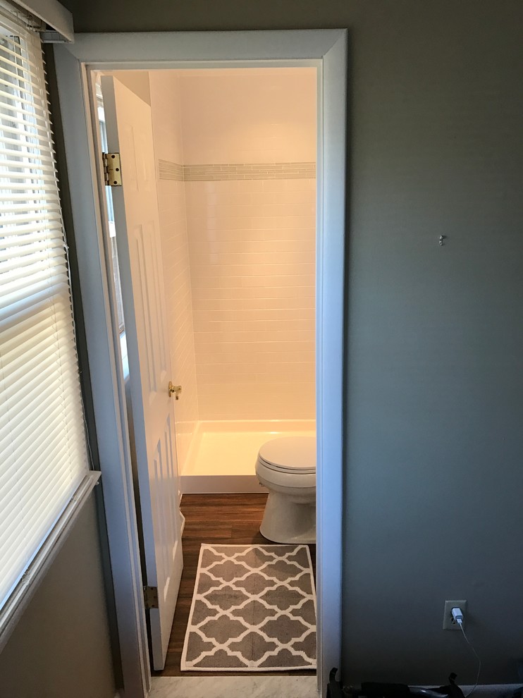 Small contemporary 3/4 bathroom in DC Metro with raised-panel cabinets, white cabinets, an alcove shower, a two-piece toilet, white tile, ceramic tile, grey walls, porcelain floors, an undermount sink, marble benchtops, brown floor and a sliding shower screen.