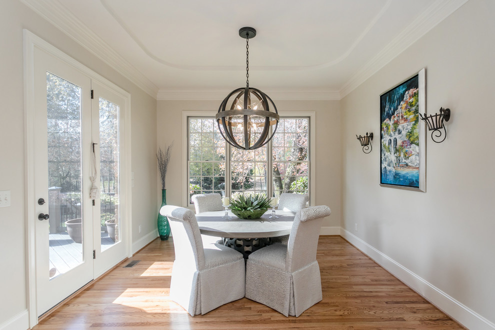 Example of a transitional laminate floor and brown floor kitchen/dining room combo design with a double-bowl sink, beaded inset cabinets, white cabinets, quartz countertops, stainless steel appliances, an island, white countertops and beige walls