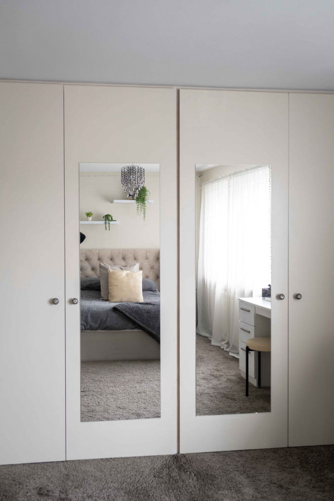 Ejemplo de dormitorio contemporáneo de tamaño medio con moqueta, estufa de leña, marco de chimenea de ladrillo y suelo gris