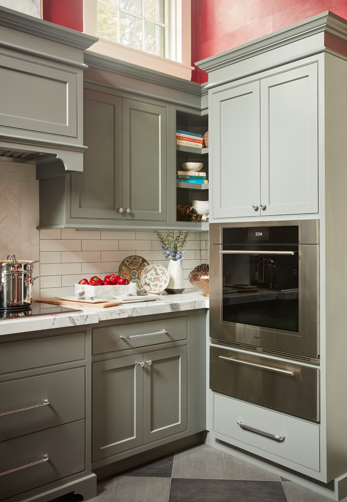 Inspiration for a mid-sized transitional u-shaped porcelain tile and gray floor enclosed kitchen remodel in Boston with an undermount sink, marble countertops, white backsplash, paneled appliances, an island, shaker cabinets, green cabinets and subway tile backsplash