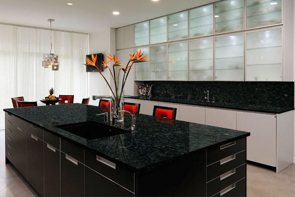 Inspiration for a mid-sized modern galley cement tile floor and beige floor open concept kitchen remodel in Baltimore with an undermount sink, flat-panel cabinets, white cabinets, granite countertops, black backsplash, stone slab backsplash, stainless steel appliances and an island