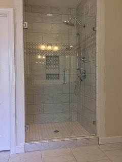 Large transitional master alcove shower photo in Raleigh with a hinged shower door