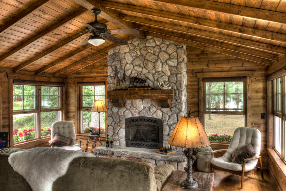 Design ideas for a country family room in Minneapolis with a standard fireplace and a stone fireplace surround.