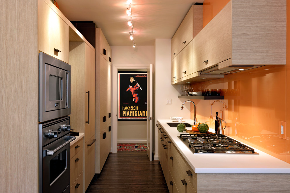 Small contemporary galley eat-in kitchen in DC Metro with flat-panel cabinets, no island, an undermount sink, light wood cabinets, quartzite benchtops, orange splashback, stainless steel appliances, dark hardwood floors and glass sheet splashback.