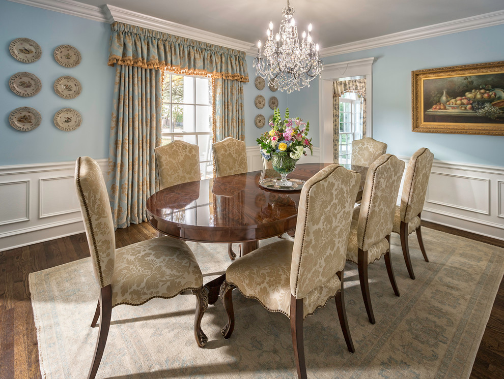 This is an example of a large traditional separate dining room in Dallas with blue walls and dark hardwood floors.