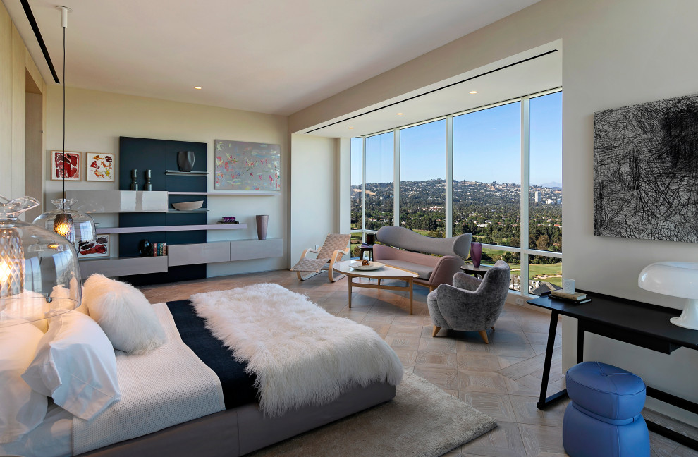 This is an example of a contemporary bedroom in Los Angeles with beige walls, medium hardwood floors and brown floor.