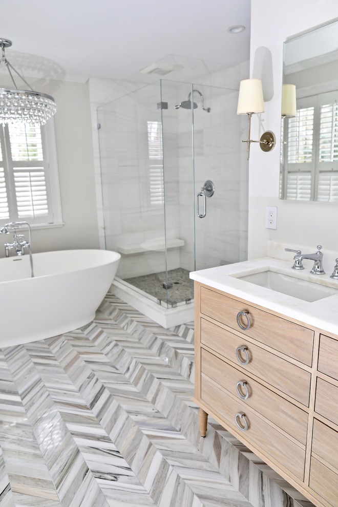 Freestanding bathtub - large transitional master white tile and marble tile marble floor and multicolored floor freestanding bathtub idea with furniture-like cabinets, distressed cabinets, gray walls, an undermount sink, marble countertops, a hinged shower door and white countertops