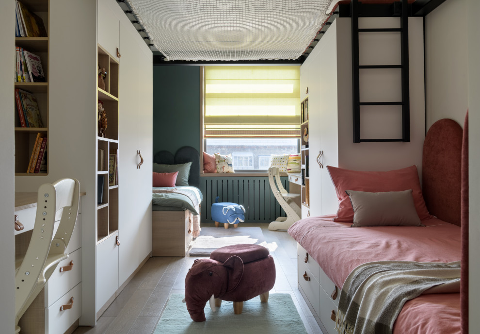 This is an example of a contemporary gender neutral kids' bedroom in Novosibirsk with light hardwood flooring and beige floors.