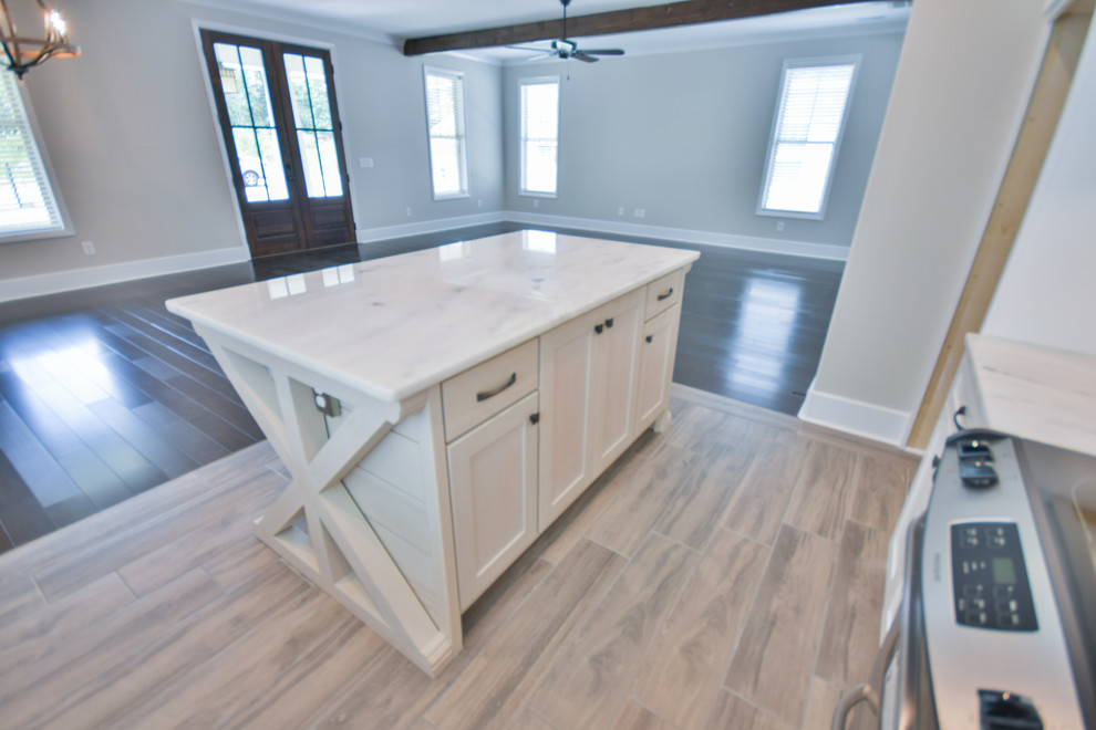 Design ideas for a mid-sized transitional l-shaped kitchen in Other with a farmhouse sink, shaker cabinets, white cabinets, marble benchtops, porcelain floors, with island and grey floor.