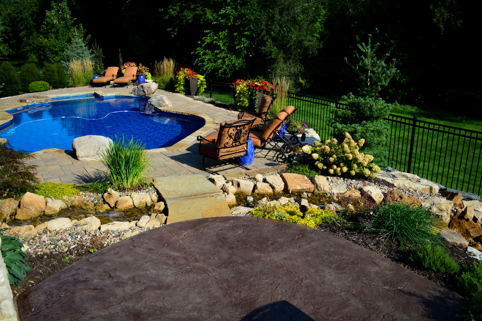 Pool fountain - mid-sized rustic backyard gravel and custom-shaped pool fountain idea in Omaha