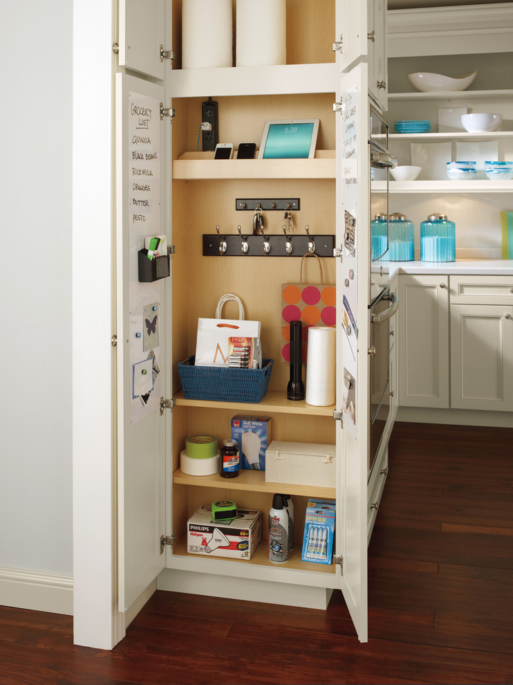 Design ideas for a traditional l-shaped kitchen pantry in Other with medium hardwood floors, white benchtop, recessed-panel cabinets, beige cabinets and white splashback.