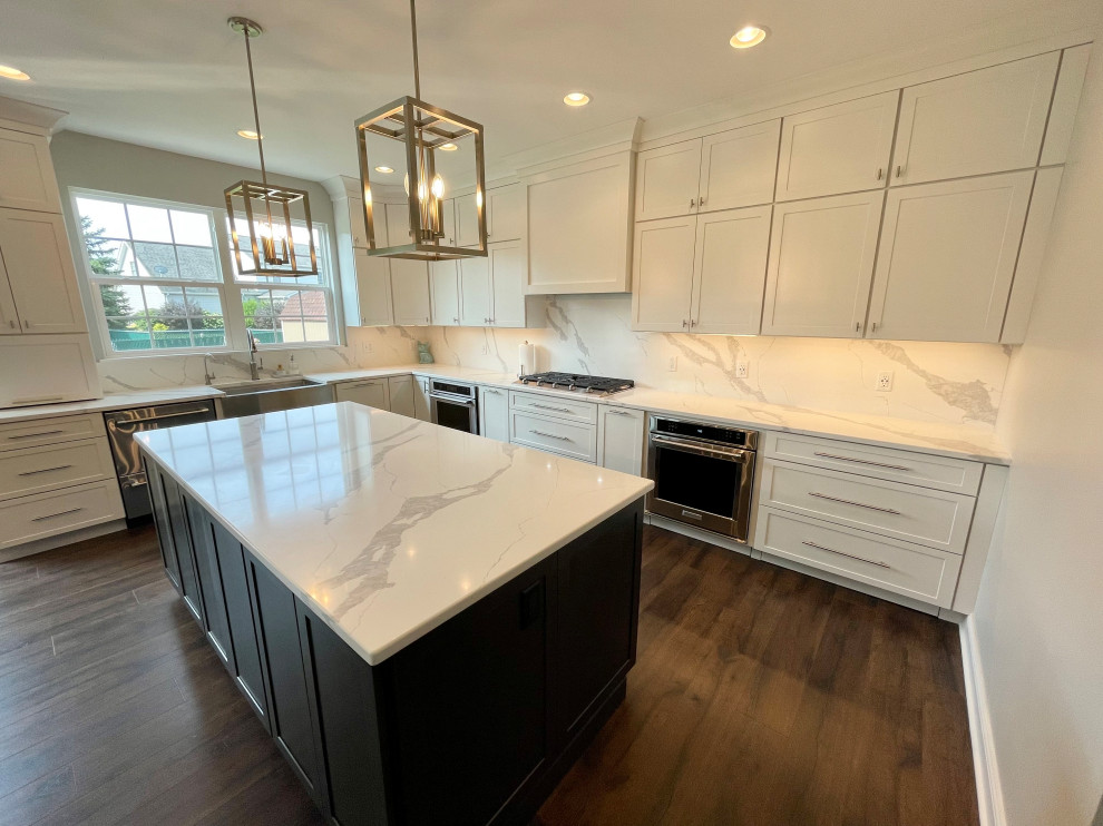Inspiration for a large transitional u-shaped medium tone wood floor and brown floor eat-in kitchen remodel in Chicago with a farmhouse sink, shaker cabinets, white cabinets, quartz countertops, white backsplash, quartz backsplash, stainless steel appliances, two islands and white countertops
