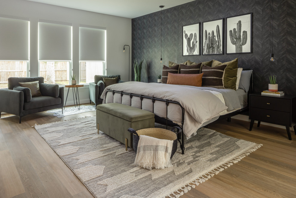 This is an example of a contemporary bedroom in Houston with black walls, medium hardwood floors, brown floor and wallpaper.